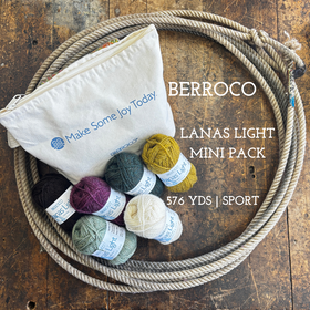 Mini balls of wool yarn with a zipper pouch on a wooden surface