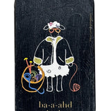 Small rectangular black tin with a cartoon design of a sheep with yarn on a white background
