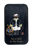 Small rectangular black tin with a cartoon design of a sheep with yarn on a white background