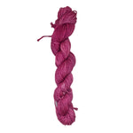 A skein of pink grey yarn on a white background