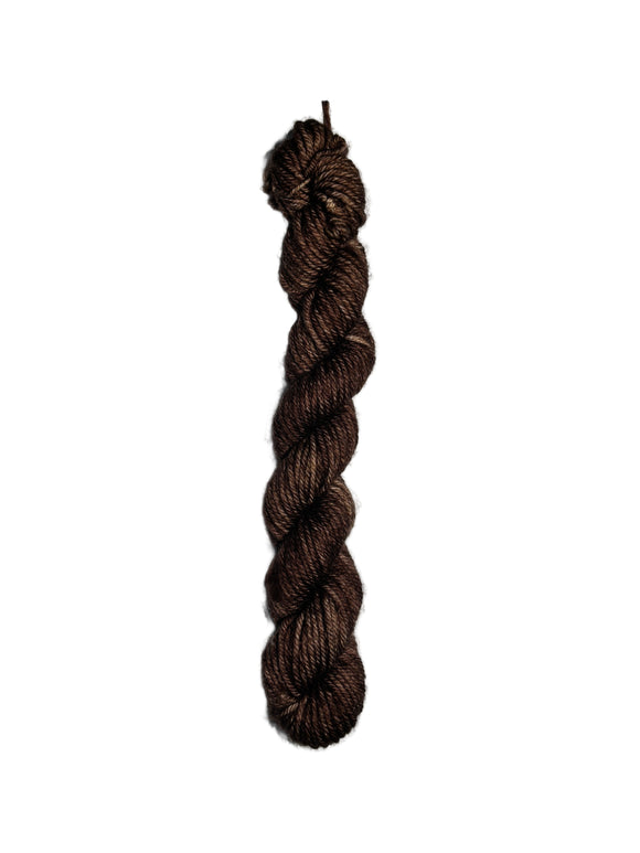 Brown skein of wool yarn on a white background