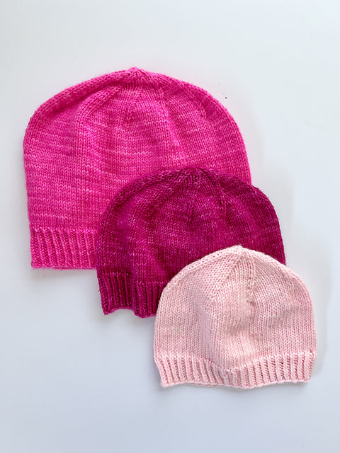 3 Base Doodle Beanies in various sizes knit in the colors pink magenta and light pink