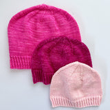 3 Base Doodle Beanies in various sizes knit in the colors pink magenta and light pink