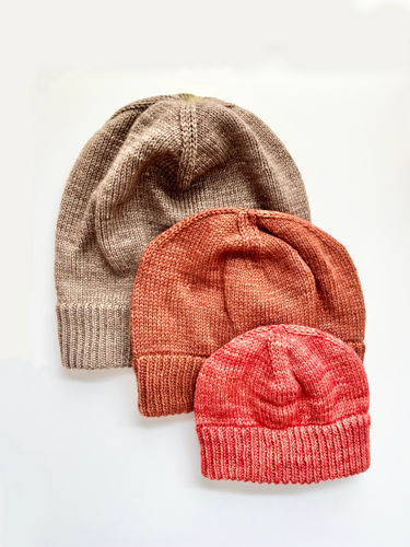 3 Base Doodle Beanies in various sizes knit up in brown orange and coral colored yarns