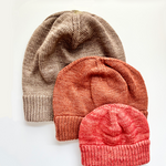 3 Base Doodle Beanies in various sizes knit up in brown orange and coral colored yarns
