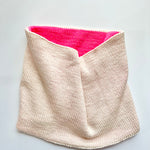 A Base Doodle Reversible Cowl knit in the colors off-white and pink