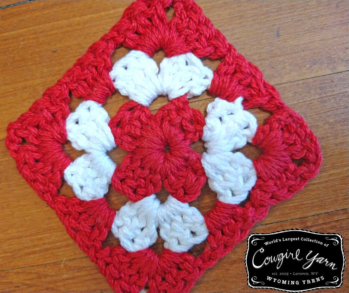 A red and white, crocheted granny square