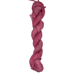 A skein of pink rose colored yarn on a white background