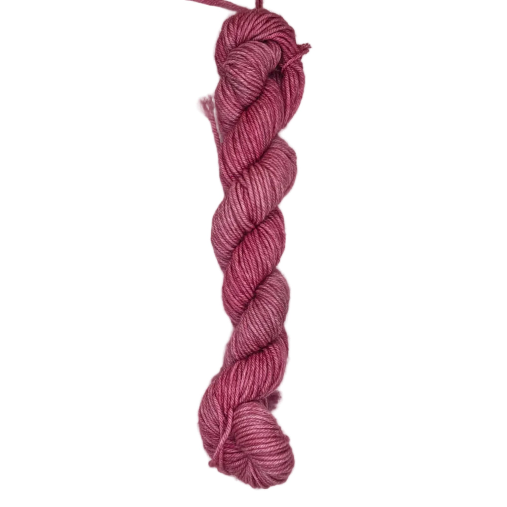 A skein of pink rose colored yarn on a white background