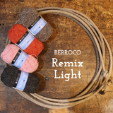 Four skeins of Berroco Remix Light yarn in black, pink, rust orange, and taupe, arranged next to a large coiled jute rope on a rustic wooden background with white text reading 'BERROCO Remix Light'.