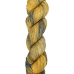 A skein of hand-dyed fingering/sock yarn color yellow navy speckles