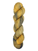 A skein of hand-dyed fingering/sock yarn color yellow navy speckles