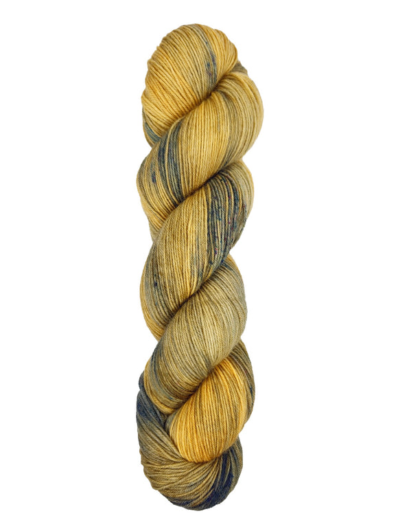 A skein of hand-dyed fingering/sock yarn color yellow navy speckles