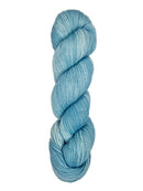 A skein of hand-dyed fingering/sock yarn color sky blue