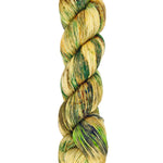 A skein of hand-dyed fingering/sock yarn color tan and green speckles