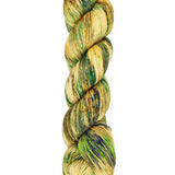 A skein of hand-dyed fingering/sock yarn color tan and green speckles