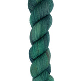 A skein of hand-dyed fingering/sock yarn color dark green