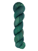 A skein of hand-dyed fingering/sock yarn color dark green