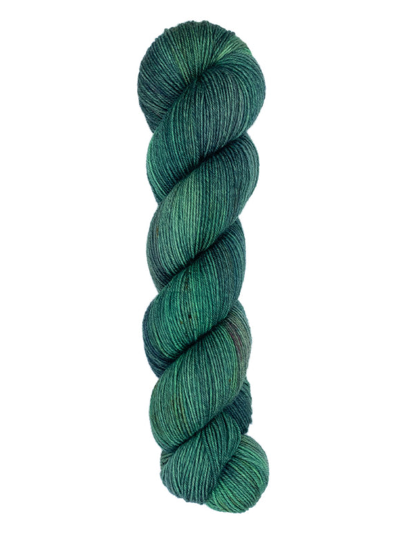 A skein of hand-dyed fingering/sock yarn color dark green