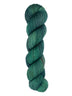 A skein of hand-dyed fingering/sock yarn color dark green