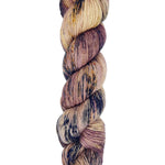 A skein of hand-dyed fingering/sock yarn color tan mauve navy brown