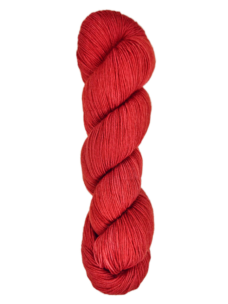 A skein of hand-dyed fingering/sock yarn color red