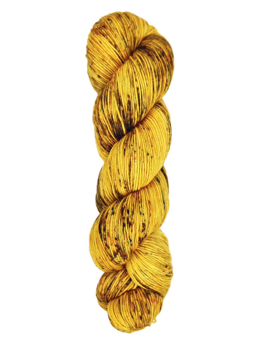 A skein of hand-dyed fingering/sock yarn color yellow brown speckles
