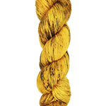 A skein of hand-dyed fingering/sock yarn color yellow brown speckles