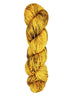 A skein of hand-dyed fingering/sock yarn color yellow brown speckles