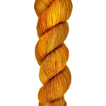 A skein of hand-dyed fingering/sock yarn color orange and brown
