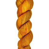 A skein of hand-dyed fingering/sock yarn color orange and brown