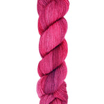 A skein of hand-dyed fingering/sock yarn color red pink