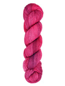 A skein of hand-dyed fingering/sock yarn color red pink