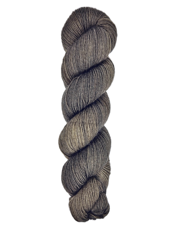 A skein of hand-dyed fingering/sock yarn color dark gray brown