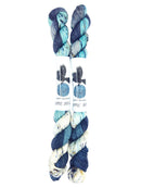 Blackbird Sycamore Fingering Mini Skein color variegated dark blue with streaks of light blue and white, and flecks of yellow and black