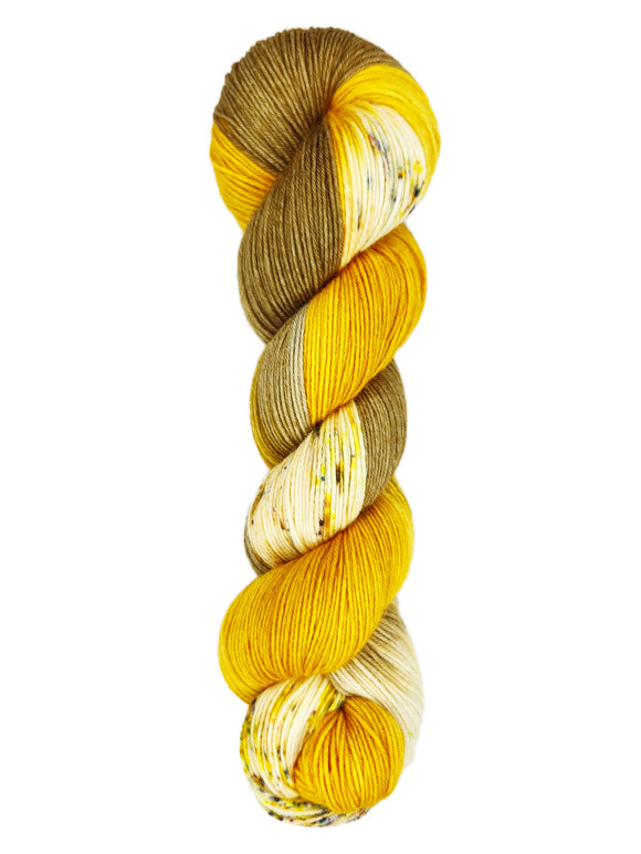 A skein of hand-dyed fingering/sock yarn color brown and gold speckles