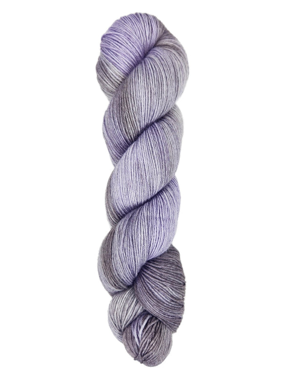 A skein of hand-dyed fingering/sock yarn color gray sky blue