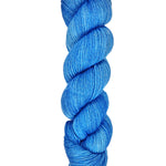 A skein of hand-dyed fingering/sock yarn color blue