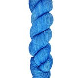 A skein of hand-dyed fingering/sock yarn color blue