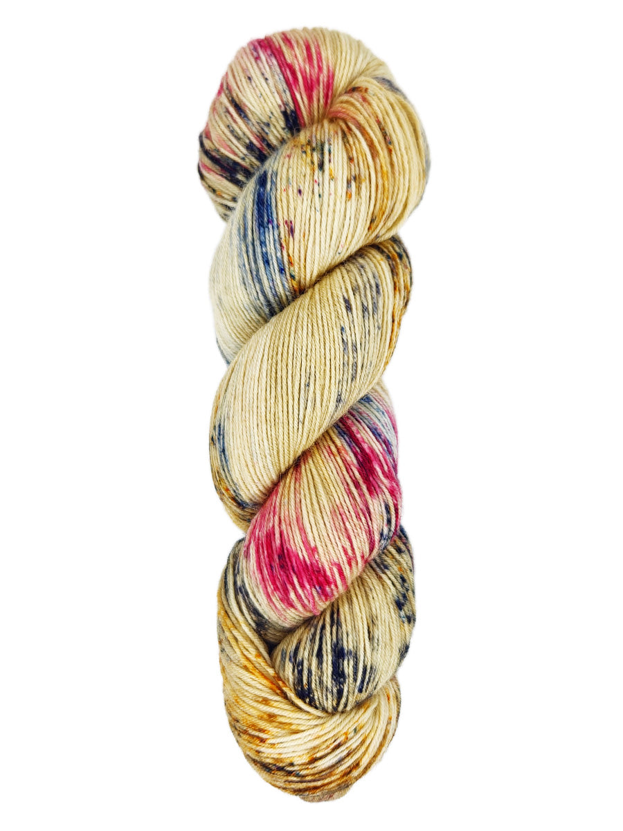 A skein of hand-dyed fingering/sock yarn color tan red and blue speckles
