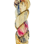 A skein of hand-dyed fingering/sock yarn color tan red and blue speckles