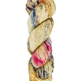A skein of hand-dyed fingering/sock yarn color tan red and blue speckles