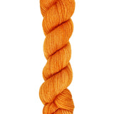 A skein of hand-dyed fingering/sock yarn color orange
