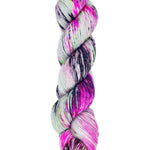 A skein of hand-dyed fingering/sock yarn color pink gray and green black speckles