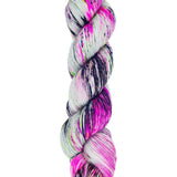 A skein of hand-dyed fingering/sock yarn color pink gray and green black speckles