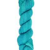A skein of hand-dyed fingering/sock yarn color teal