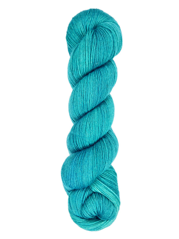 A skein of hand-dyed fingering/sock yarn color teal