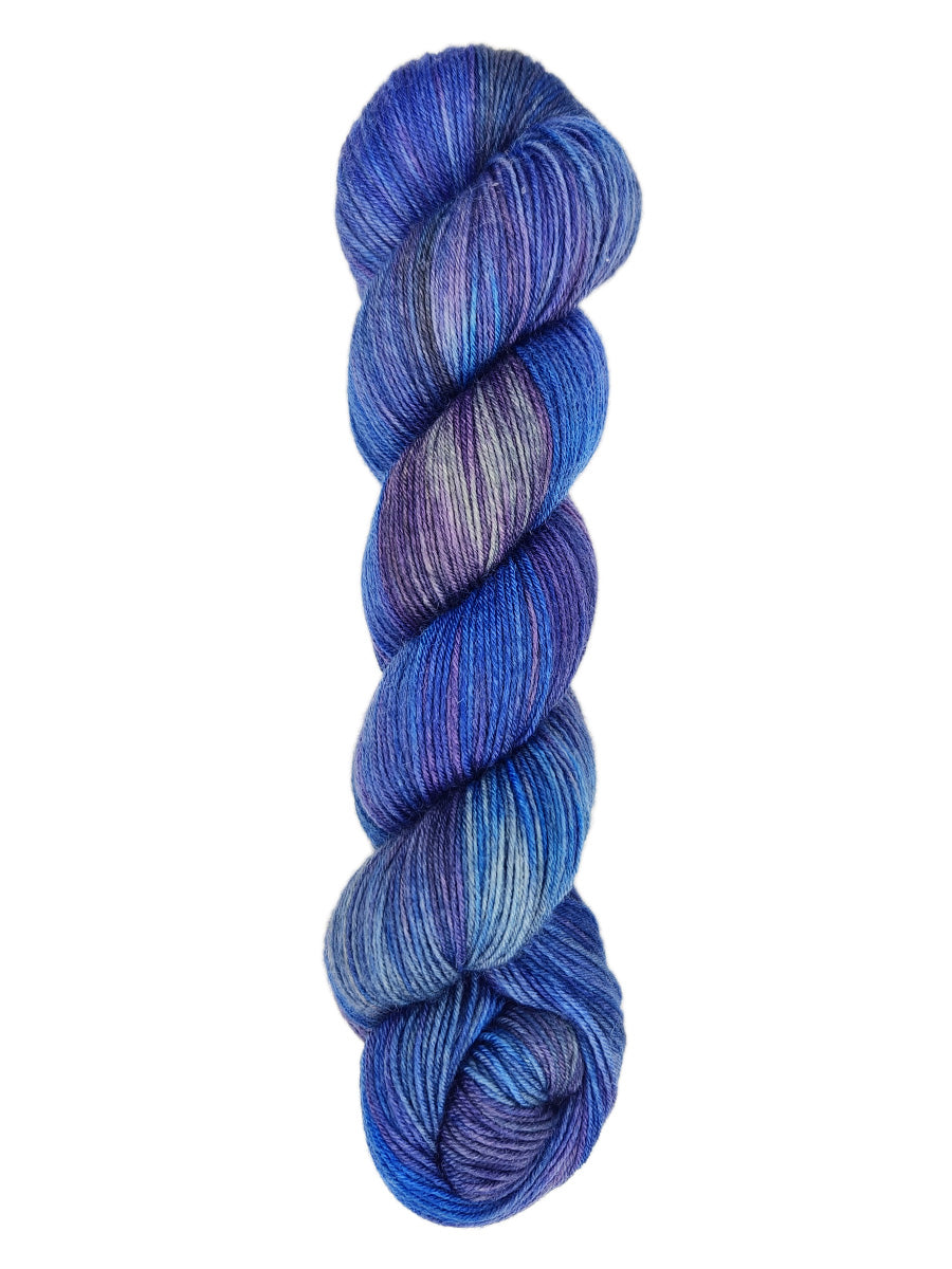 A skein of hand-dyed fingering/sock yarn color blue grey purple