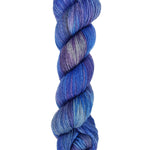 A skein of hand-dyed fingering/sock yarn color blue grey purple