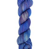 A skein of hand-dyed fingering/sock yarn color blue grey purple